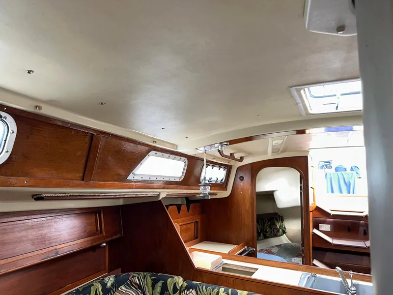 Slide: The Image of Interior of 1987 Pearson 36-2 sailboat with wooden cabinetry and seating area. - 6