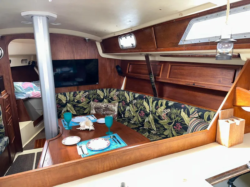 Slide: The Image of Interior of 1987 Pearson 36-2 sailboat with cozy dining area and floral upholstery. - 9