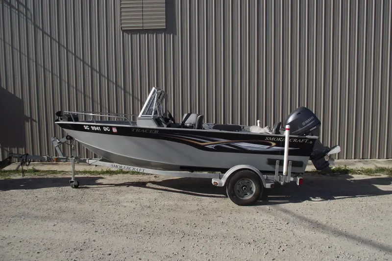 The Image of 2012 Smoker Craft Pro Angler XL 162 boat on trailer, parked outdoors. - 0