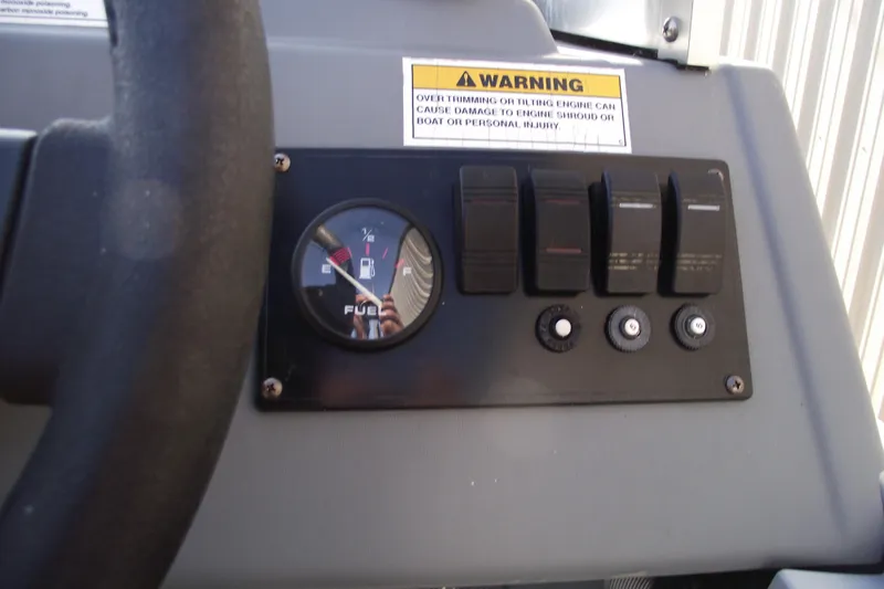 Slide: The Image of 2012 Smoker Craft Pro Angler XL 162 dashboard with fuel gauge and switches. - 10