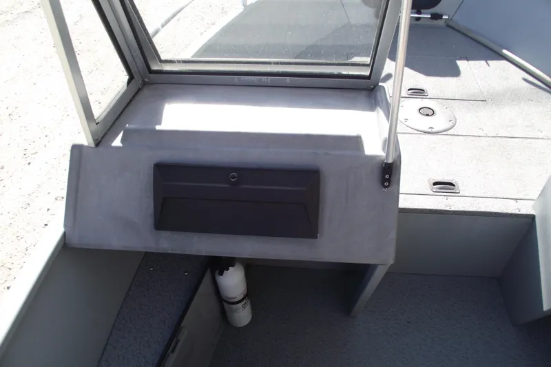 Slide: The Image of 2012 Smoker Craft Pro Angler XL 162 boat interior with storage compartment and fire extinguisher. - 11
