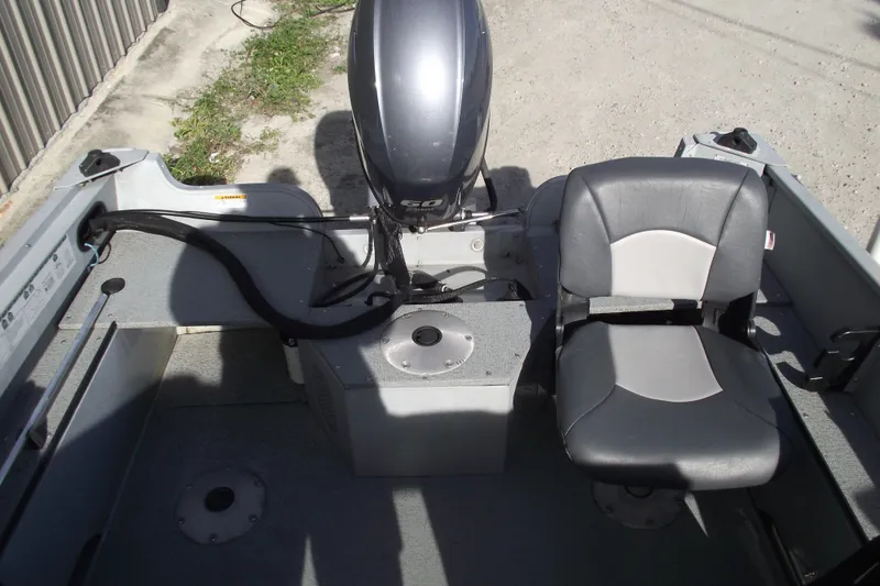 Slide: The Image of 2012 Smoker Craft Pro Angler XL 162 boat interior with motor and seating. - 16