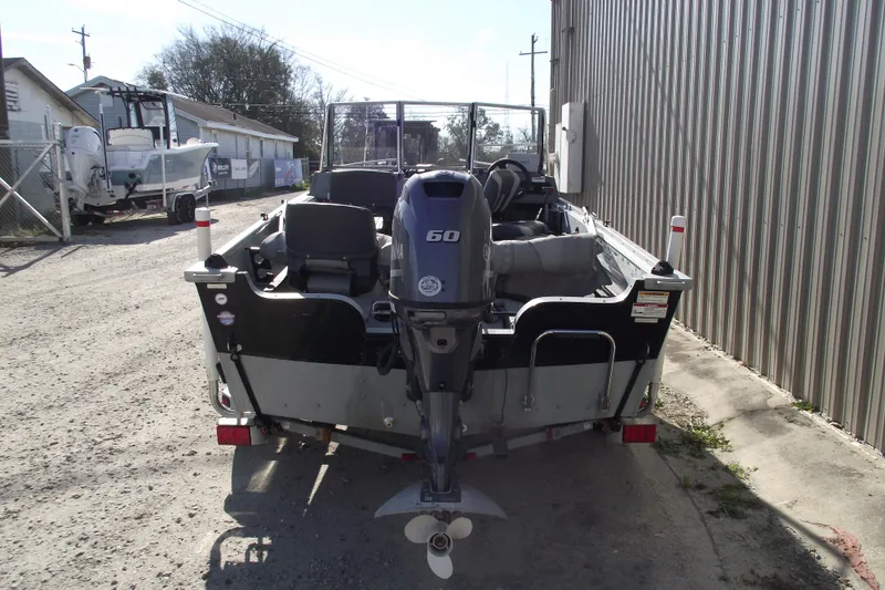 Slide: The Image of 2012 Smoker Craft Pro Angler XL 162 boat with Yamaha outboard motor, parked outdoors. - 3