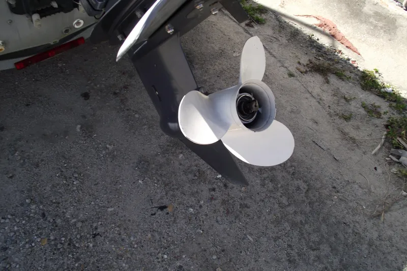 Slide: The Image of Propeller of 2012 Smoker Craft Pro Angler XL 162 boat on gravel surface. - 4