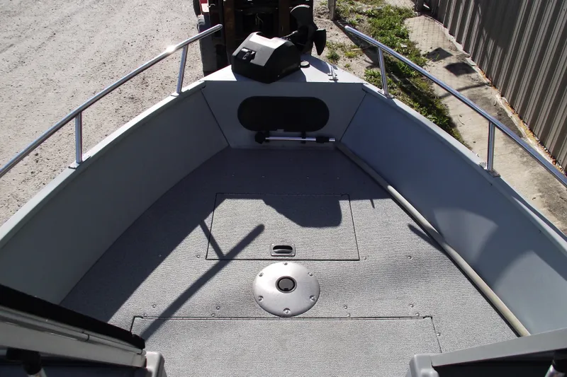 Slide: The Image of 2012 Smoker Craft Pro Angler XL 162 boat interior with carpeted deck and railing. - 5