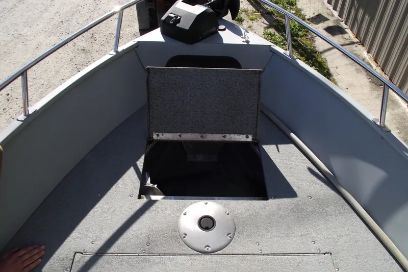 Slide: The Image of 2012 Smoker Craft Pro Angler XL 162 boat deck with open storage compartment. - 6