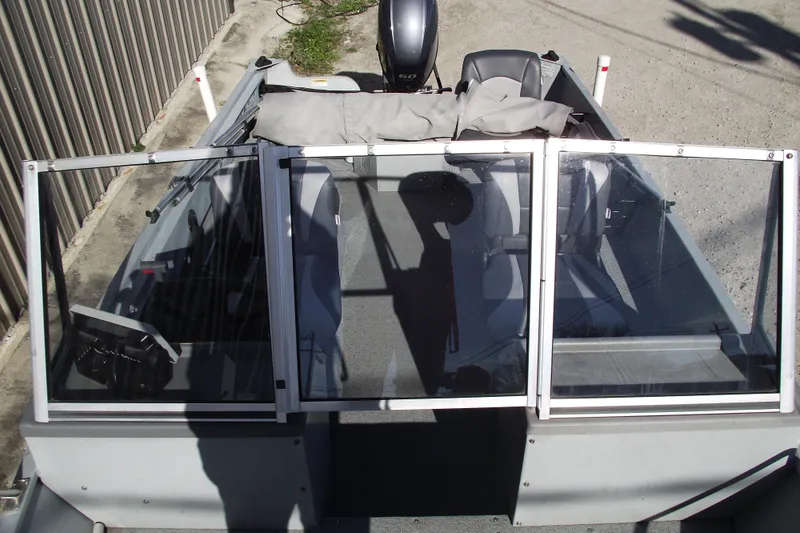 Slide: The Image of 2012 Smoker Craft Pro Angler XL 162 boat with open windshield and seating. - 7