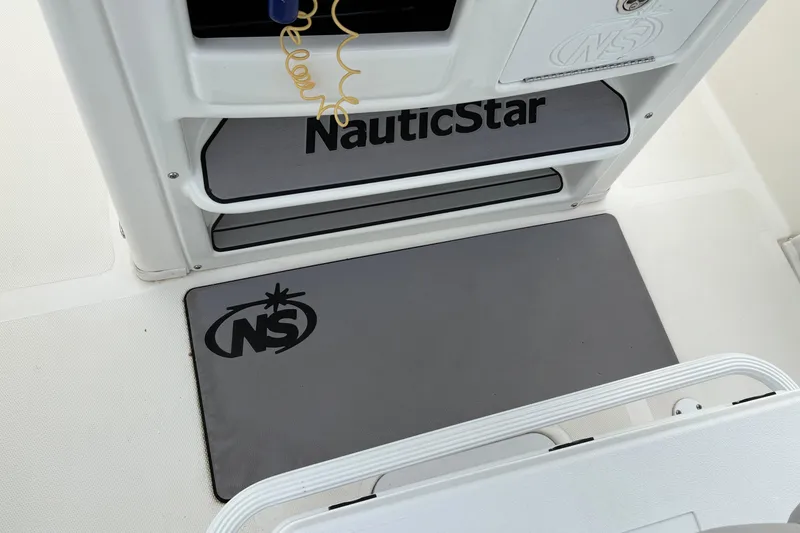 Slide: The Image of NauticStar 2302 Legacy boat interior, featuring branded mats and sleek design, 2022 model. - 17