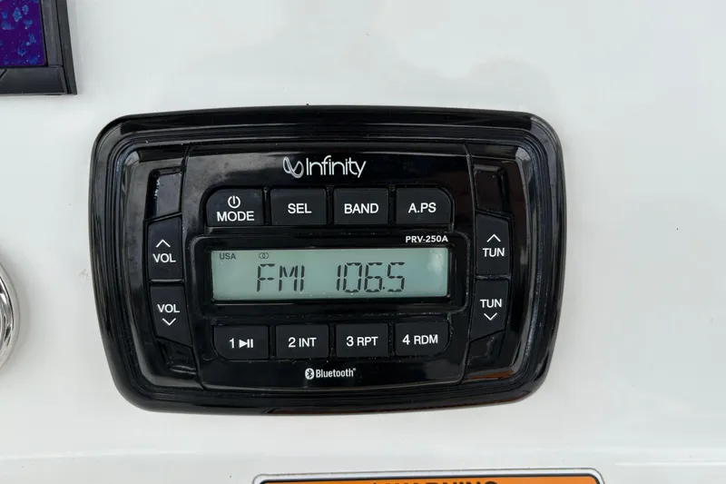 Slide: The Image of Infinity PRV-250A radio display on 2022 NauticStar 2302 Legacy boat, tuned to FM 106.5. - 20