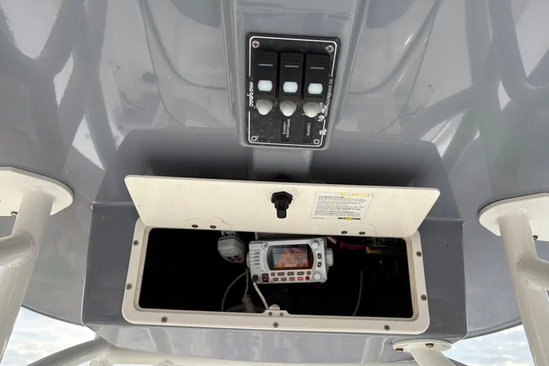 Slide: The Image of 2022 NauticStar 2302 Legacy boat console with control panel and radio compartment. - 21