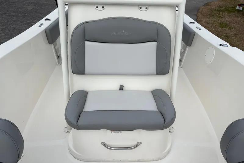Slide: The Image of 2022 NauticStar 2302 Legacy boat seat with gray and white cushioned design. - 29