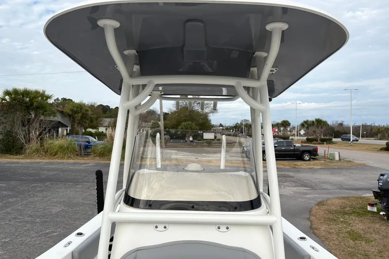 Slide: The Image of 2022 NauticStar 2302 Legacy boat with T-top, parked outdoors. - 30