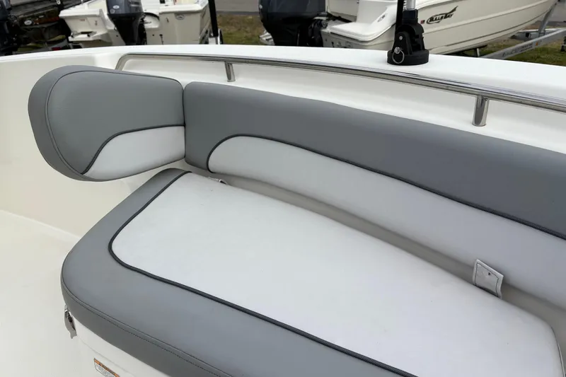 Slide: The Image of 2022 NauticStar 2302 Legacy boat with gray and white cushioned seating. - 33