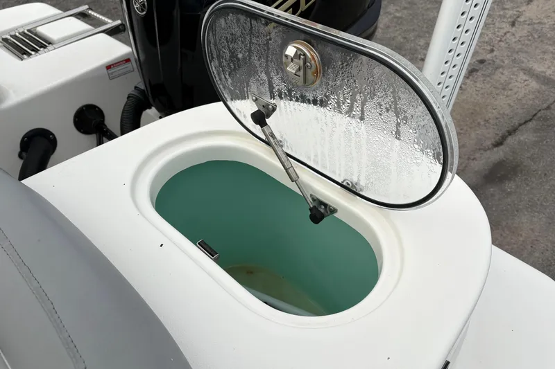 Slide: The Image of Open hatch on 2022 NauticStar 2302 Legacy boat, revealing storage compartment. - 9