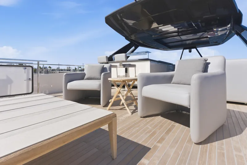 Slide: The Image of Luxurious 2018 Ferretti Yachts 920 deck with elegant seating and scenic waterfront view. - 11