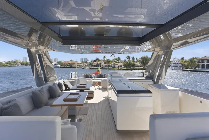 Slide: The Image of Side view of 2018 Ferretti Yachts 920 on a sunny day by the water. - 18