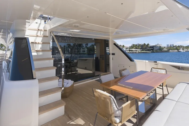 Slide: The Image of Side view of 2018 Ferretti Yachts 920 reflecting waterfront homes and blue sky. - 23