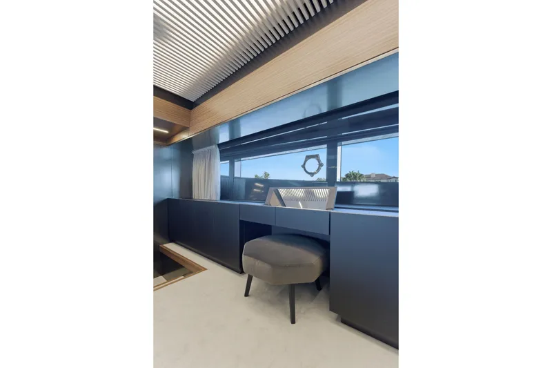 Slide: The Image of Modern interior of 2018 Ferretti Yachts 920 with sleek shelving and window curtains. - 44