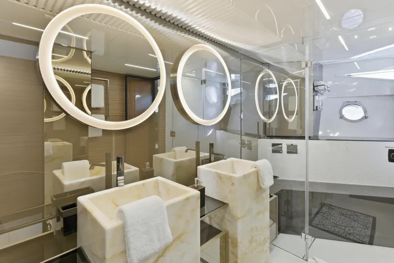 Slide: The Image of Luxurious bathroom interior of 2018 Ferretti Yachts 920 with modern fixtures and porthole window. - 51