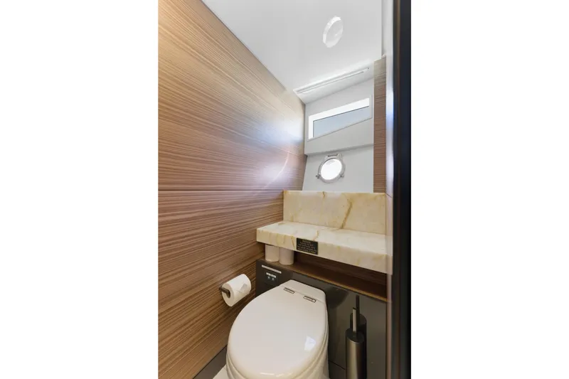 Slide: The Image of Luxurious bathroom interior of 2018 Ferretti Yachts 920 with modern wood paneling and towel rack. - 54