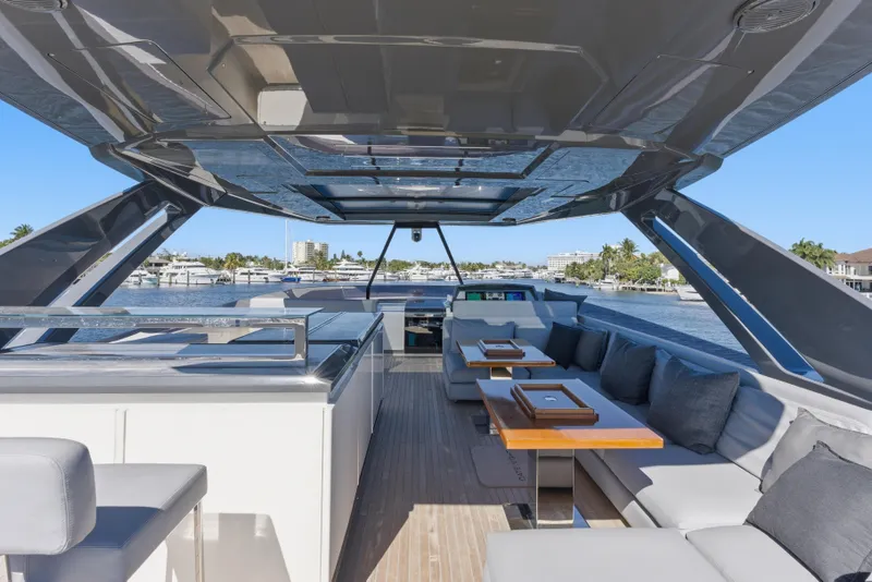 Slide: The Image of Luxurious 2018 Ferretti Yachts 920 with spacious deck and modern seating, overlooking waterfront homes. - 13