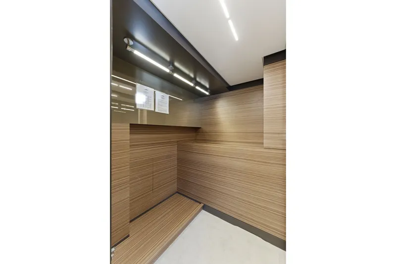 Slide: The Image of Interior of 2018 Ferretti Yachts 920 with sleek wood paneling and modern design. - 47