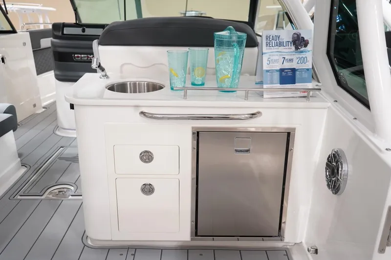 Slide: The Image of 2026 Chaparral 310 OSX boat deck with sleek gray flooring and logo design. - 3