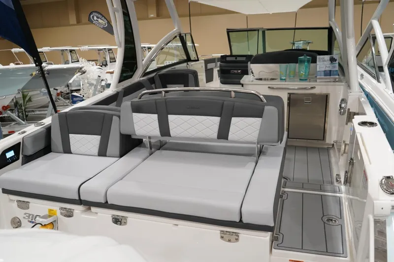 Slide: The Image of 2026 Chaparral 310 OSX boat interior with sleek seating and modern amenities. - 4