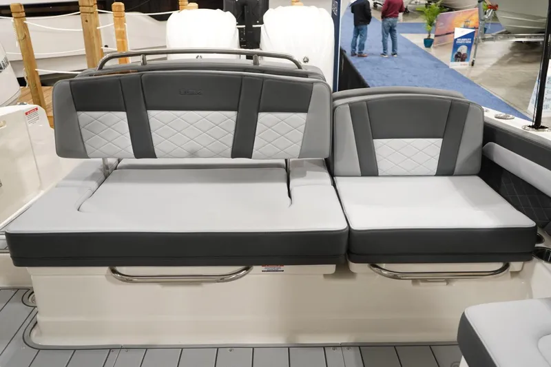 Slide: The Image of 2026 Chaparral 310 OSX boat interior with kitchenette, sink, and storage. - 5