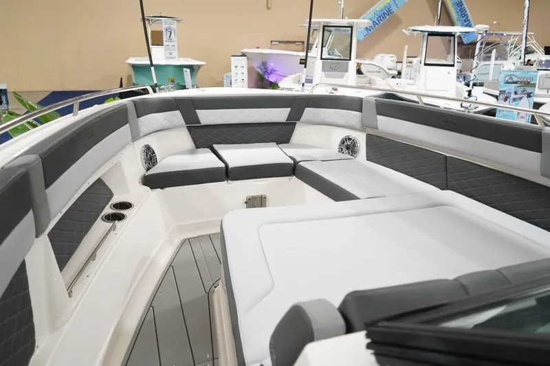 Slide: The Image of 2026 Chaparral 310 OSX cabin interior with brown seating and ambient blue lighting. - 9