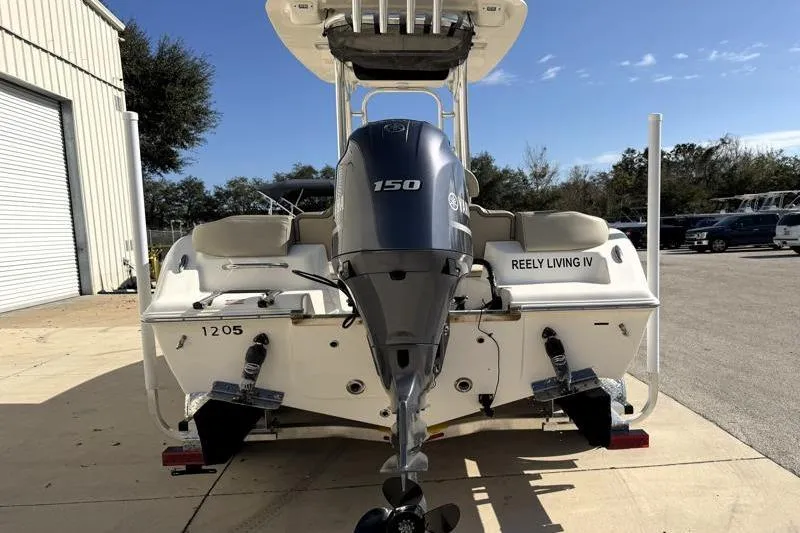 Slide: The Image of 2023 Key West 203 FS boat with 150 HP engine, parked outdoors. - 10