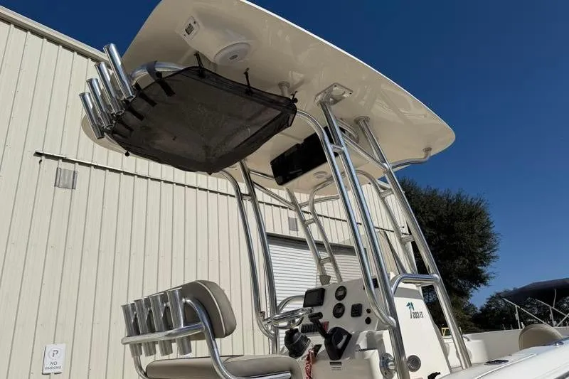 Slide: The Image of 2023 Key West 203 FS boat with T-top and rod holders, parked outdoors. - 15