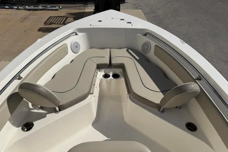 Slide: The Image of 2023 Key West 203 FS boat interior with beige seating and cup holders. - 16