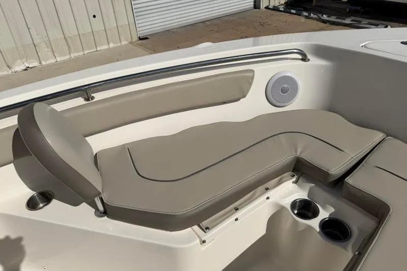 Slide: The Image of 2023 Key West 203 FS boat interior with cushioned seating and cup holders. - 18