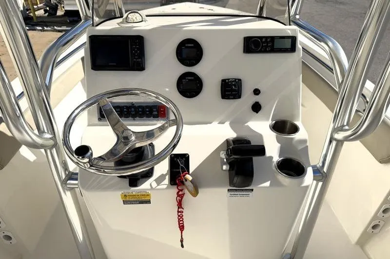 Slide: The Image of 2023 Key West 203 FS boat console with steering wheel and control panel. - 25