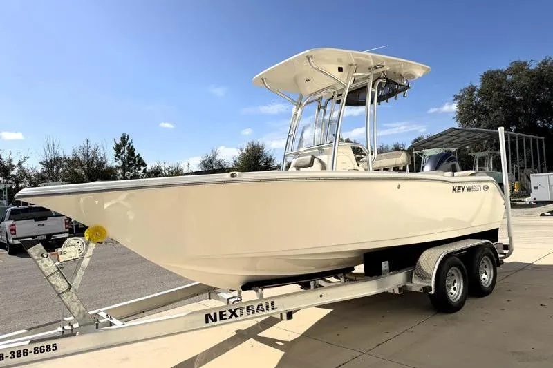 Slide: The Image of 2023 Key West 203 FS boat on trailer under clear blue sky. - 3