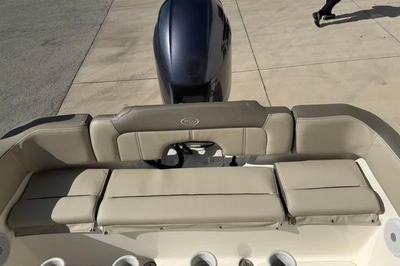 Slide: The Image of 2023 Key West 203 FS boat with beige seating and outboard motor. - 33