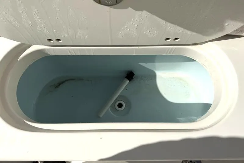 Slide: The Image of 2023 Key West 203 FS boat livewell interior with drain and pipe. - 34