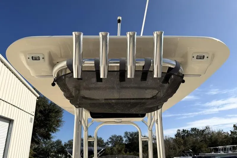 Slide: The Image of 2023 Key West 203 FS boat with rod holders and T-top under clear blue sky. - 36