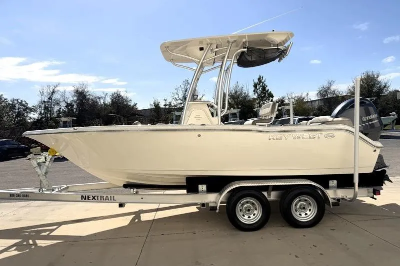 Slide: The Image of 2023 Key West 203 FS boat on trailer, side view, outdoors. - 4