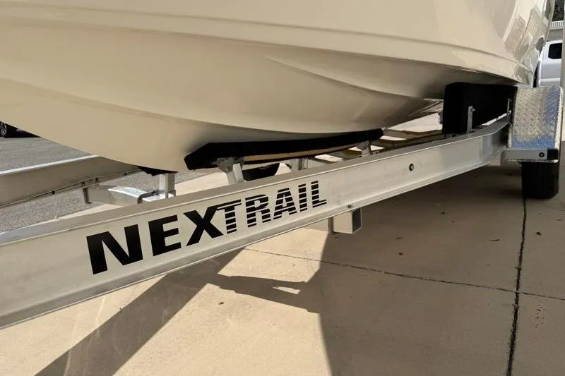Slide: The Image of 2023 Key West 203 FS boat on NexTrail trailer, parked on pavement. - 42