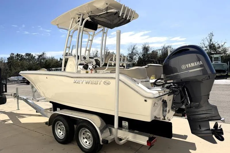 Slide: The Image of 2023 Key West 203 FS boat on trailer with Yamaha engine, parked outdoors. - 5