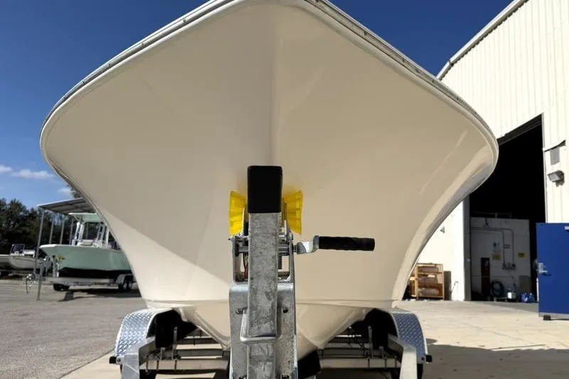 Slide: The Image of 2023 Key West 203 FS boat on trailer outside a warehouse. - 7