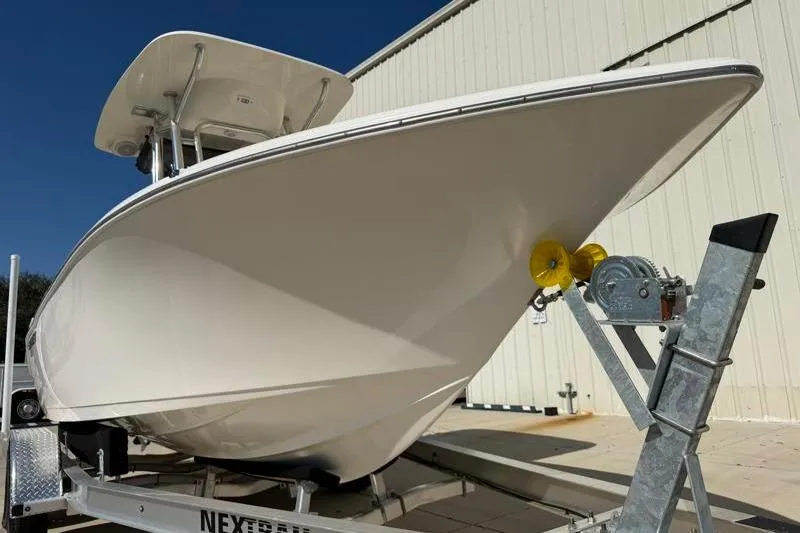 Slide: The Image of 2023 Key West 203 FS boat on trailer, side view against building. - 8