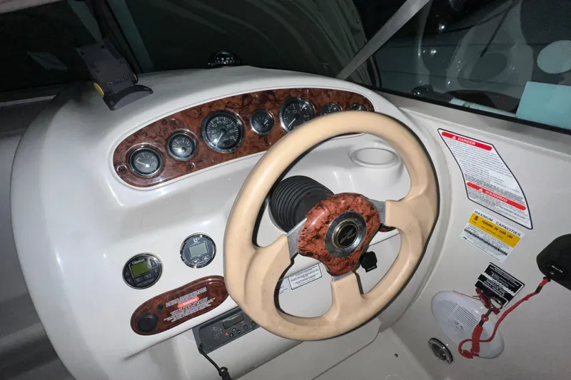 Slide: The Image of 2003 Sea Ray 225 Weekender dashboard with steering wheel and instrument panel. - 10