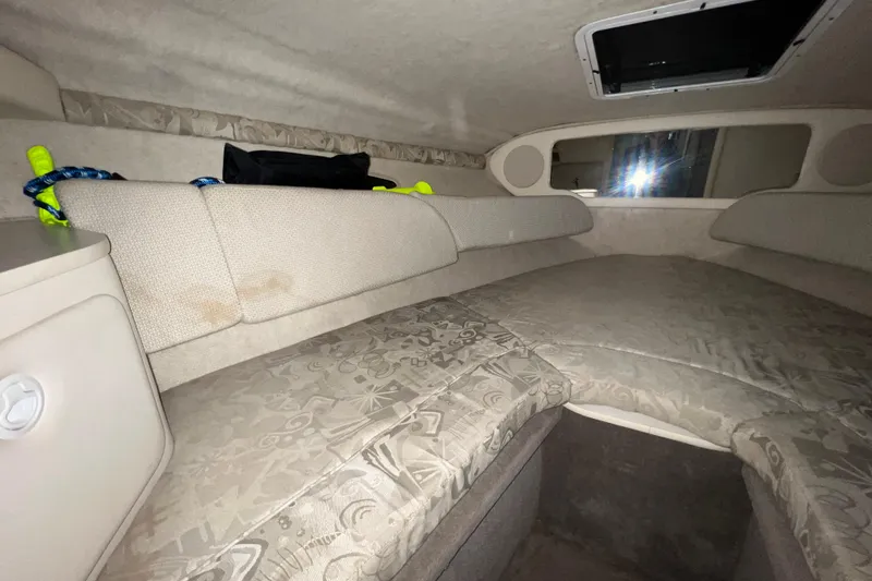 Slide: The Image of Interior cabin of 2003 Sea Ray 225 Weekender with cushioned seating and storage. - 15