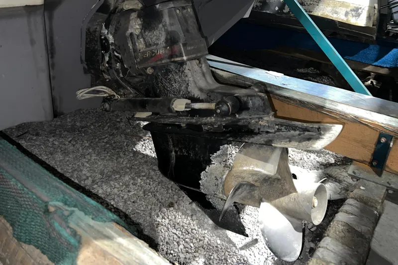 Slide: The Image of 2003 Sea Ray 225 Weekender boat propeller and drive system in a maintenance setting. - 19