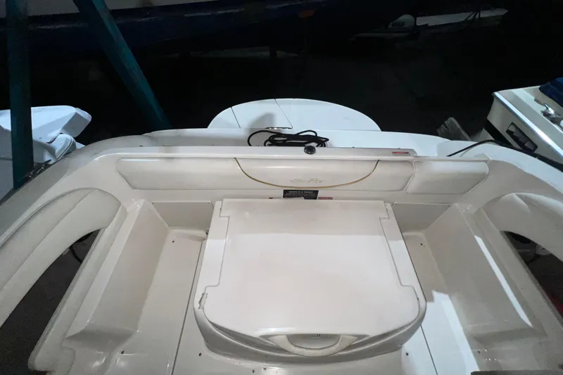 Slide: The Image of 2003 Sea Ray 225 Weekender boat interior with seating and storage area. - 5