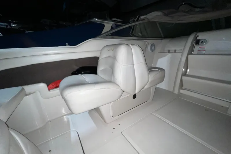 Slide: The Image of Interior of 2003 Sea Ray 225 Weekender boat with white seating and dashboard. - 6