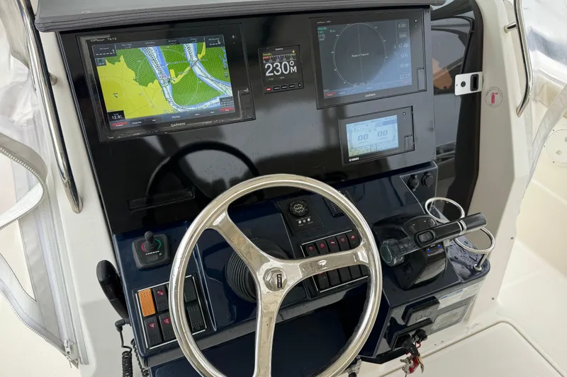 Slide: The Image of 2018 Pursuit S 328 Sport helm with Garmin navigation displays and steering wheel. - 13
